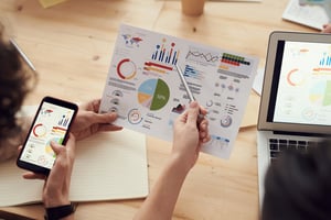 Professionals analysing graphs on a document