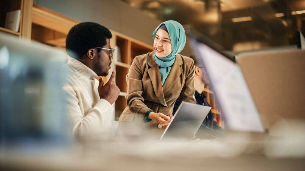 Male and female professionals talking in an office